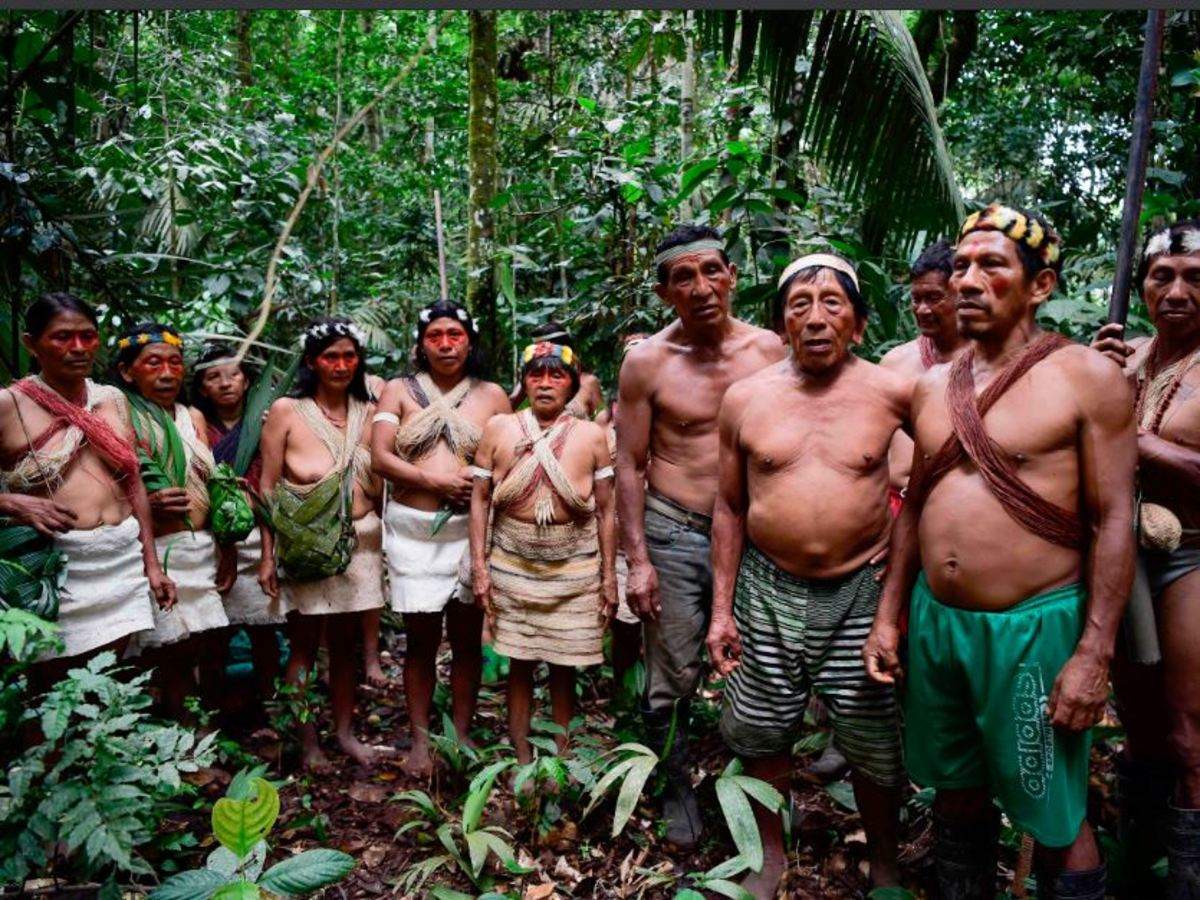 Waorani indigenous people sing to thank nature at the Teata sacred waterfall, near the village of Nemompare, on the banks of the Curaray river, in Pastaza Province, Ecuador