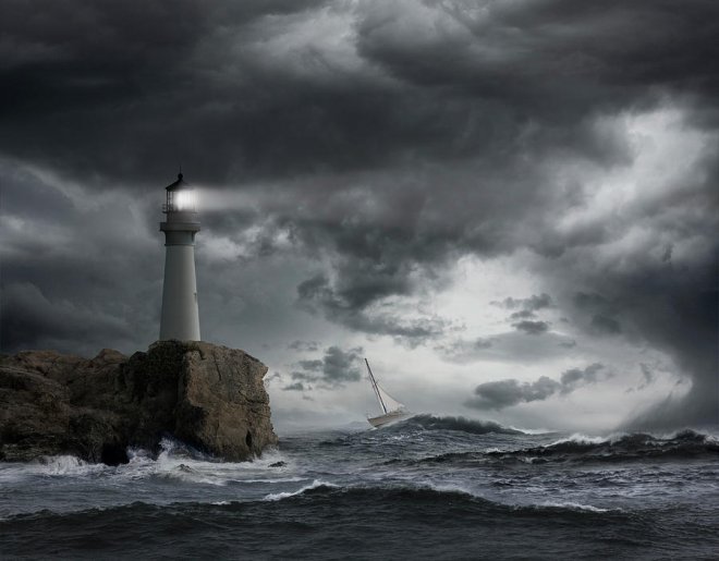 https://assets.roar.media/assets/DFxtawlVLt7F8CMa_lighthouse-shining-over-stormy-ocean-john-m-lund-photography-inc.jpg