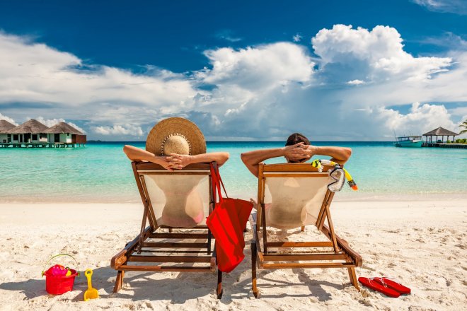 https://assets.roar.media/assets/GqfsTWwSl563s4oD_man-and-woman-relaxing-in-lounge-chairs-on-a-beach-in-the-maldives-mature-couple-vacation-early-retirement.jpg