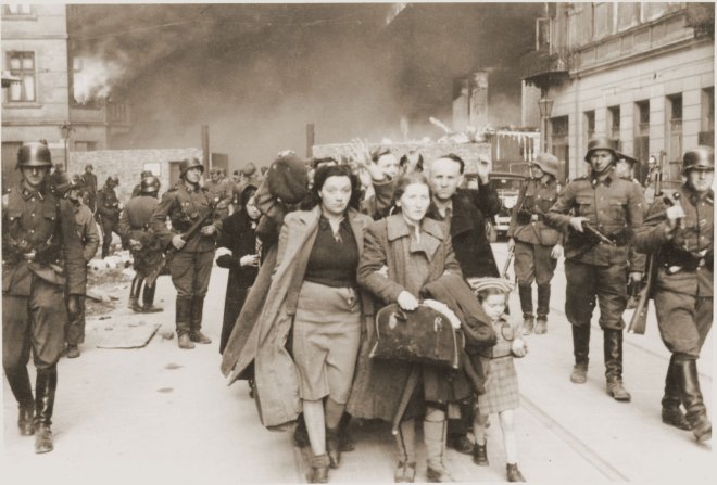 https://assets.roar.media/assets/M9hJw5cwUGI4lu0Z_family-marching-Jews-head-column-way-Warsaw-1943.jpg