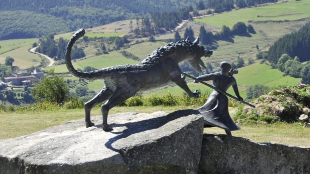 A statue of Marie-Jeanne Valet fighting the Beast of Gévaudan in France.
